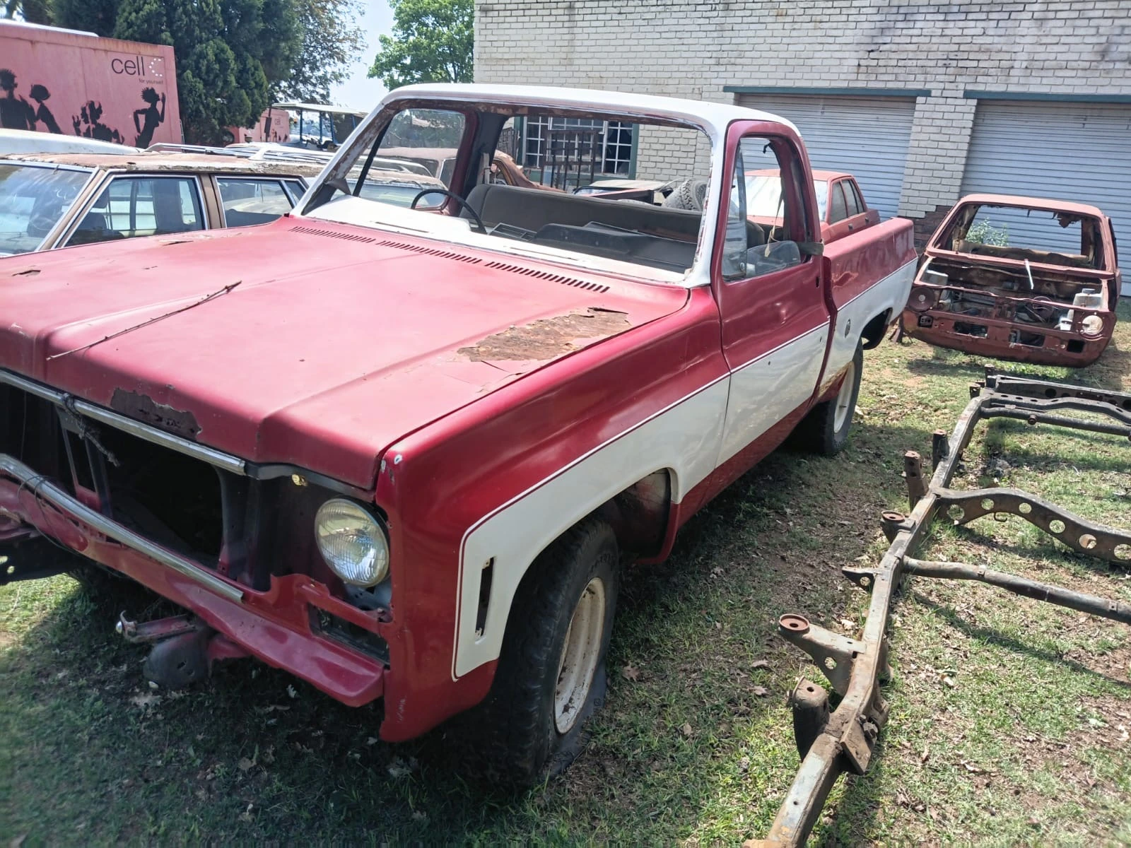 Red-and-white C10 project pickup showing the bonnet, cab and incomplete front grille