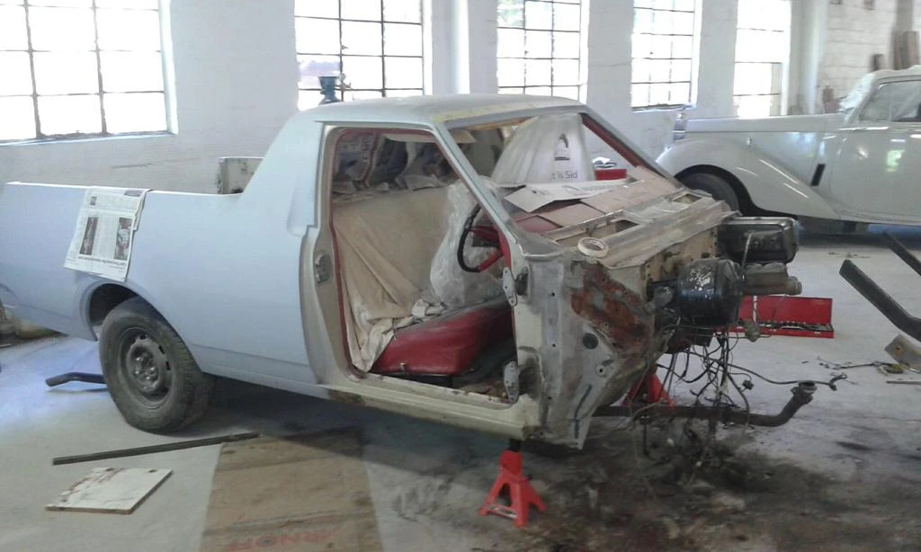 Front panels and doors removed, exposing the cab, chassis and engine area for access.