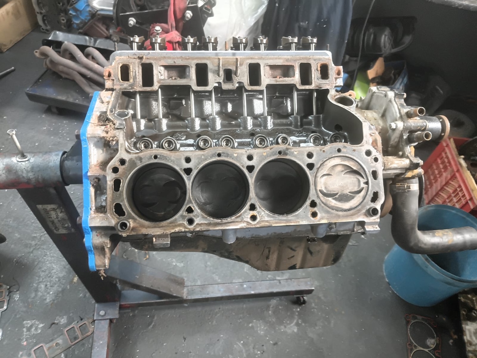 Exposed cylinder bank and pistons during engine strip-down.